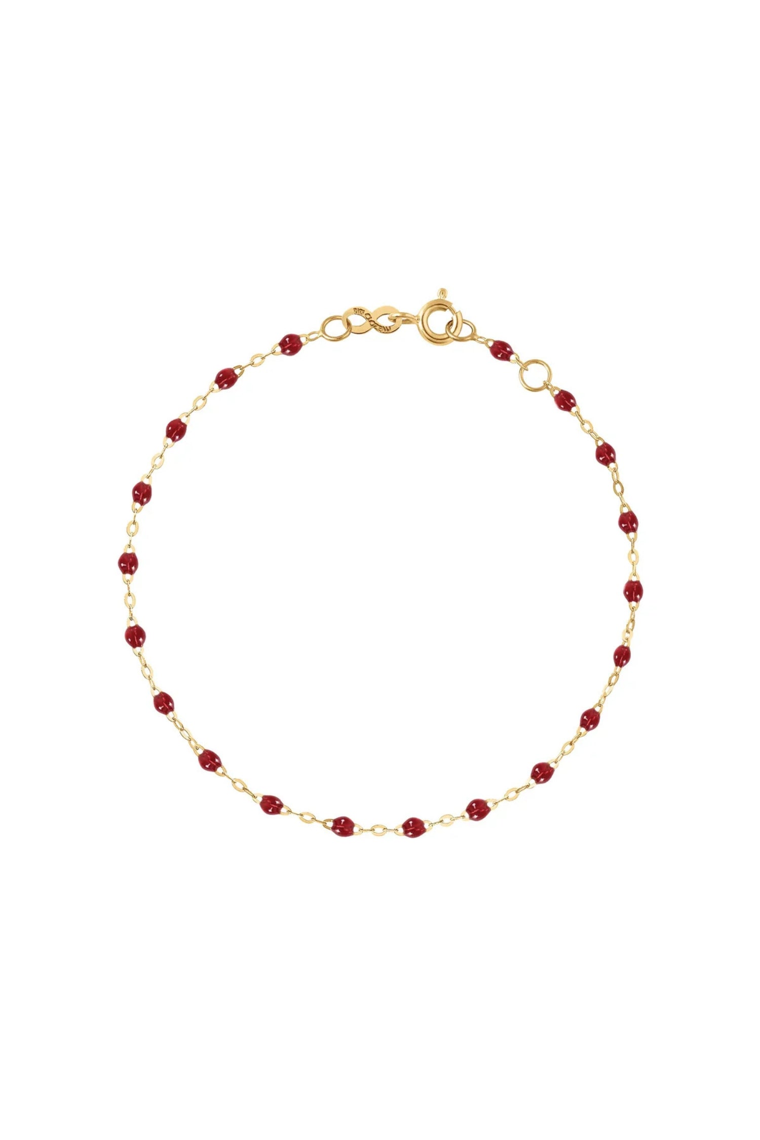 Gold bracelet with red beads 