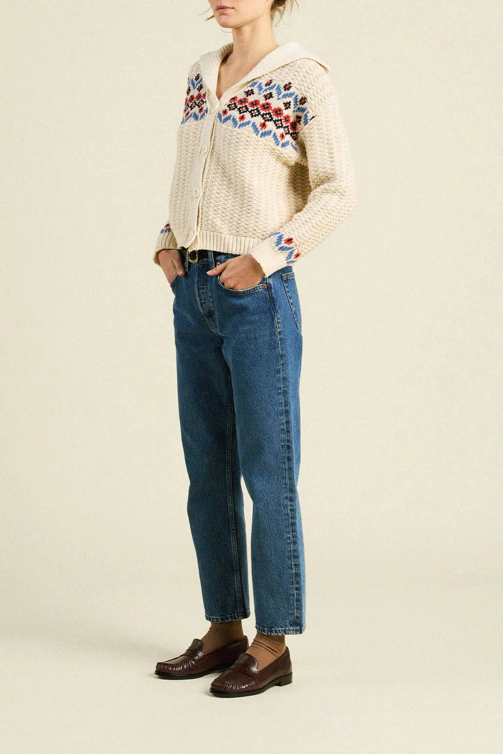 An off-white grandma cardigan with red and blue knit